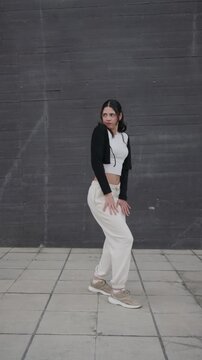 Young woman performing afrobeat and hip hop dance moves outdoors