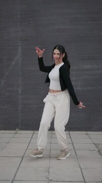 Young woman dancing afrobeat hip hop outdoors