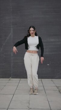 Young energetic woman performing modern afrobeat dance