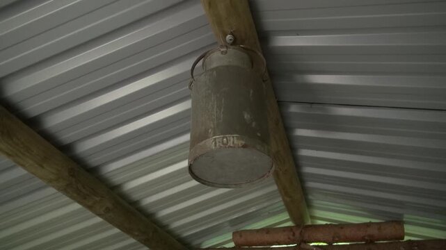 Milk bucket can churn jug luggie pail metal old rust ceiling beams logs vigas