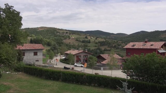 Town village houses Mollo road mountains nature trees afternoon day clouds