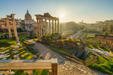 Naklejka premium Ruins of Roman forum at sunrise with inscription 