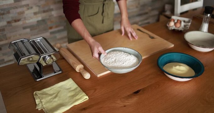 Woman preparing dough for homemade pasta at home - Italian food, culture and lifestyle concept