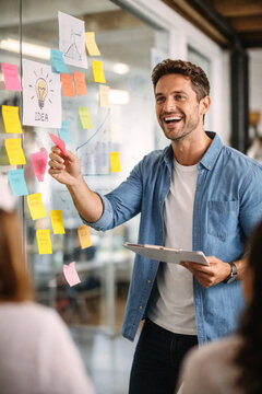 portrait of a young man holding a credit card