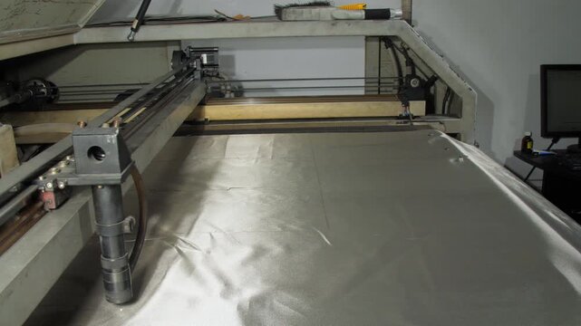 Cutter meticulously processes shielding fabric closeup. Special machine craft components effectively blocking unwanted radio signals