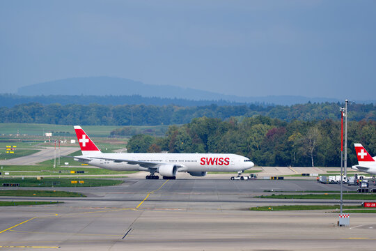 Swiss passenger airplane type Boeing 777-300ER registration HB-JNB pushback at Swiss Z&uuml;rich Airport on an autumn day. Photo taken September 29th, 2025, Zurich Airport, Switzerland.