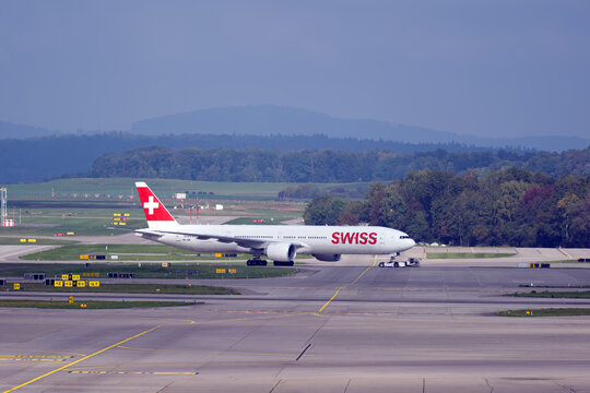 Swiss passenger airplane type Boeing 777-300ER registration HB-JNB pushback at Swiss Z&uuml;rich Airport on an autumn day. Photo taken September 29th, 2025, Zurich Airport, Switzerland.