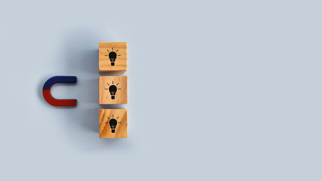 Vertical stack of idea blocks beside a magnet representing structured thinking and organized creativity.