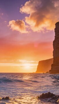 Vertical video: Breaking swell striking wet rocky jetty at sunset, erupting spray then leaving foam