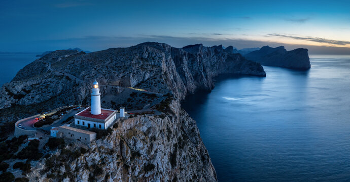 Formentor Lighthouse panorama with cliff and sea at dusk from drone, Majorca, Spain