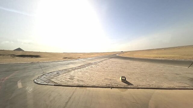 GIZA, EGYPT - APRIL 5, 2026: Scenic view of the ancient Giza Pyramids and the surrounding desert landscape with tourists and camels