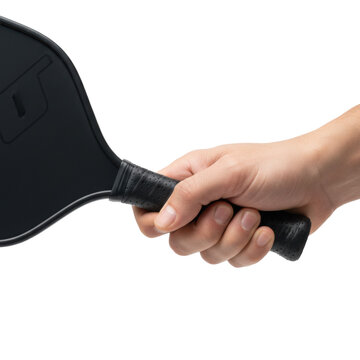 Athletic human hand with neutral skin tone firmly grips a modern black pickleball paddle, textured grip, against a transparent studio background, conveying athletic readiness