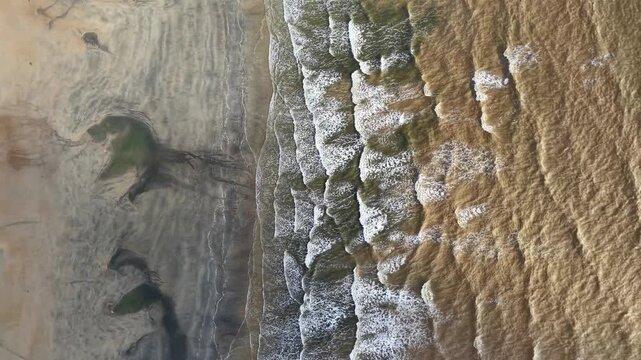 Ocean waves crash against rugged cliffs