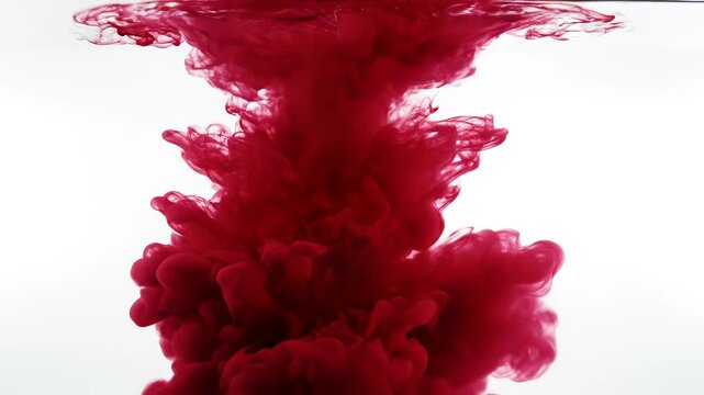 Red ink dispersing in water for commercial backgrounds, digital design, and advertising