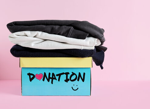 Clothing donation box with stacked garments for charity