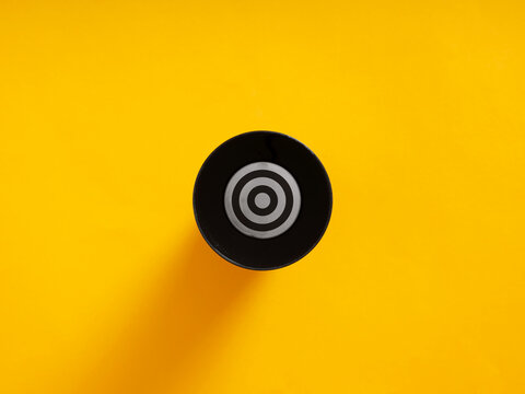 Bullseye target symbol with rings on yellow background
