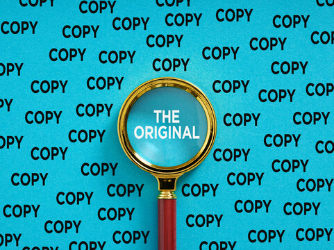 Magnifying glass finding the original among copies