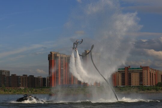 Flyboarding is an extreme water sport and entertainment that allows a person to float in the air above the water using a powerful water flow.