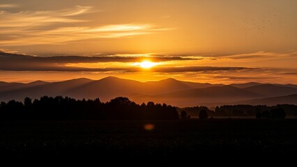 Obraz premium Beautiful Golden Sunrise over Mountains and Forest Silhouette Landscape