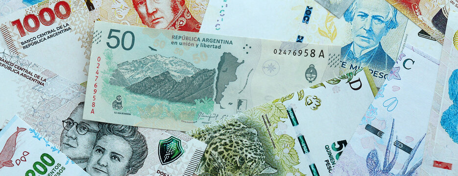 Argentine peso money banknotes pile on table. Argentina bills of ARS currency close up