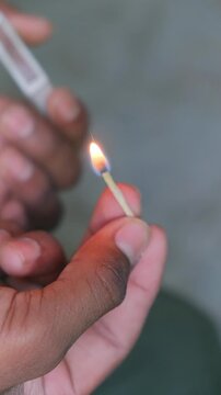 Striking Matchstick to Ignite Flame Close Up