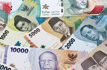 Indonesian rupiah money banknotes pile on table. Indonesia bills of IDR currency close up © Larysa