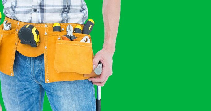 Mid section of a repairman with multiple tools against black background