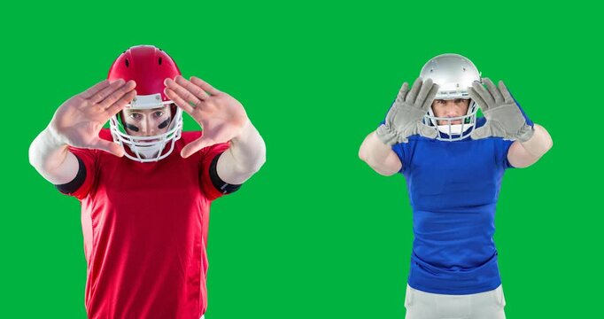 Two male rugby players wearing helmets with hands in front of their faces against black background