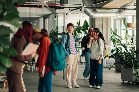 Diverse students walking through a modern university campus building, learning and networking in a community environment