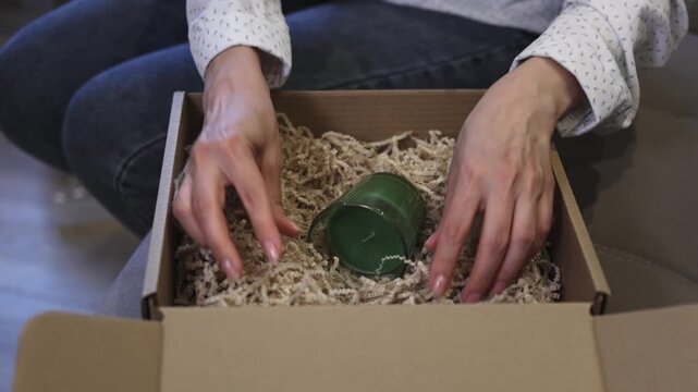 Cardboard box. Bell. Clay. Gift wrapping. Slow motion video. High quality 4k footage