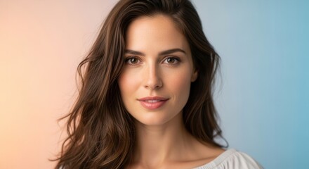 Fototapeta premium A radiant portrait of a beautiful young woman with flowing brown hair and a gentle, natural smile