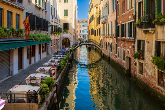 Romantic dining area by the water in Venice, Italy, with historic architecture