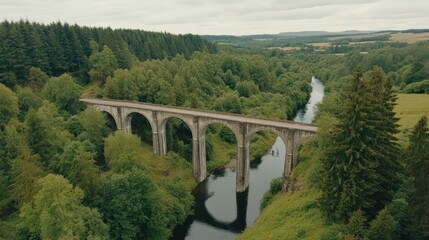 Obraz premium Stone bridge in lush green valley