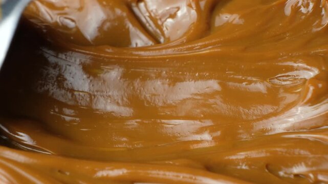Boiled condensed milk texture or dulce de leche background