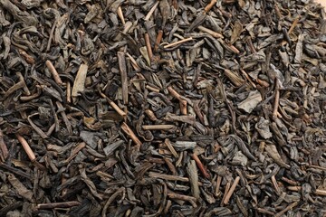 Fototapeta premium Dry herbal tea leaves as background, top view