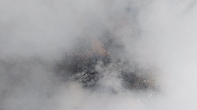 Aerial drone footage of fire burning at landfill site