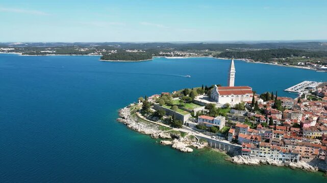 Aerial drone footage of Rovinj, Croatia: historic old town, Adriatic coastline and iconic church skyline. Ideal for travel, tourism and Mediterranean city projects.