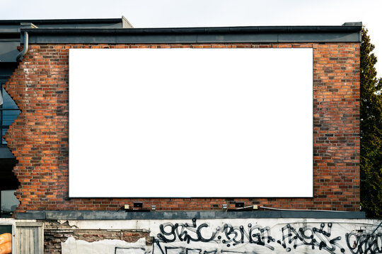 Blank advertising poster on a scenic brick wall in the city