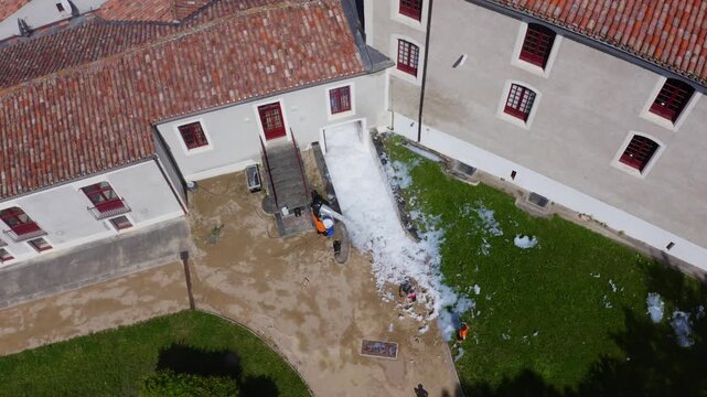 Aerial View of Foam Spill Cleaning Near Historic Building Entrance