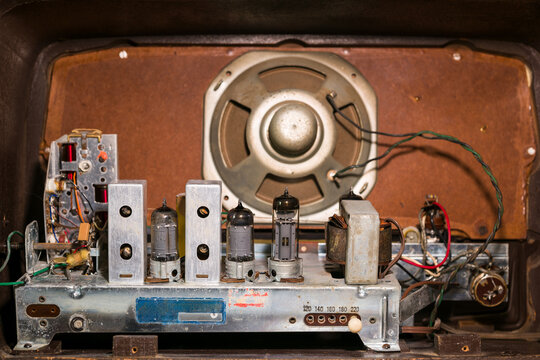 Interior of an old radio with valves and electrical components.