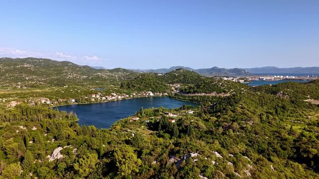 Aerial panoramic view of the Bacina Lakes surrounded by lush green hills and Mediterranean vegetation in Croatia