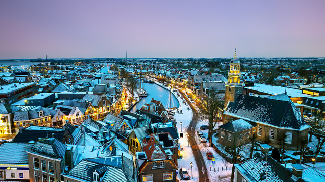 Snowy winter sunset over a historic maritime town