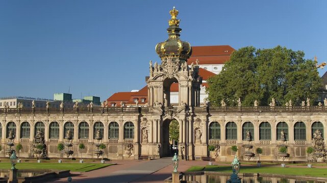 Close-up of the Dresden Crown Gate at the Zwinger. The magnificent Baroque architecture with its golden crown and galleries shines against a clear blue sky.
