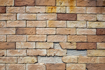 Fototapeta premium Old brick wall surface with rough texture and natural wear forming simple architectural material background.