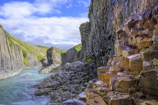 Basalt columns coloured orange by iron oxide, Stu&eth;lagil Canyon, Egilssta&eth;ir, Austurland, Iceland
