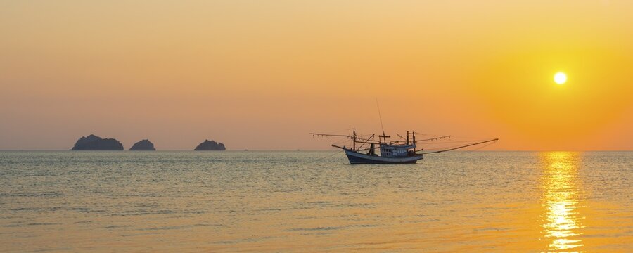 Boat in the sea at sunset in front of small islands, Koh Samui, Gulf of Thailand, Thailand