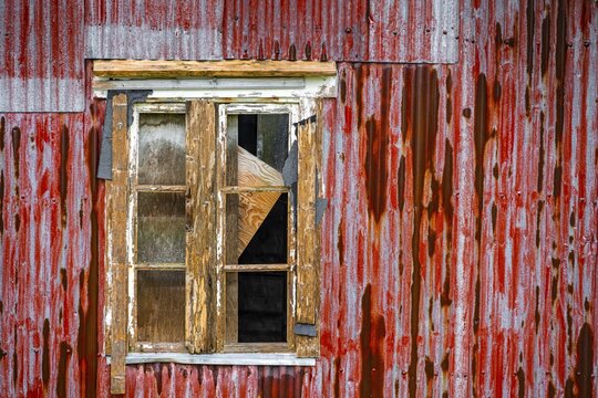 Broken window of a dilapidated wooden house, Lofoten, Norway, Norway