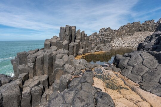 Water gathering between rocks, Roman Bath, Hexagonal basalt column by the Sea, Blackhead, Dunedin, Otago, South Island, New Zealand