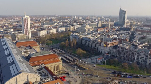 Extensive aerial view of the city of Leipzig in daylight, showing the urban center and dense development from a bird's-eye perspective.