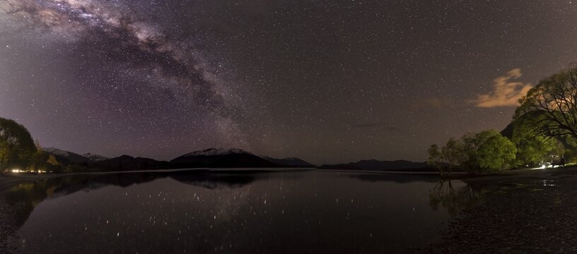 Night Scene, Wanaka lake with stars and Milky Way, stars mirroring in the water, Glendhu Bay, Otago, Southland, New Zealand